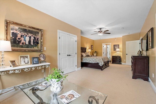 bedroom featuring carpet floors, baseboards, and a ceiling fan