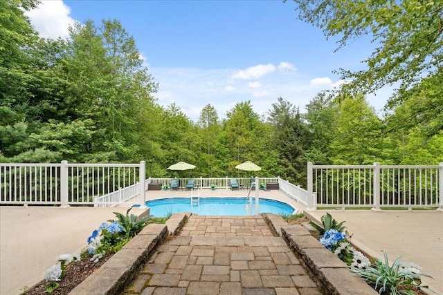 view of swimming pool featuring fence