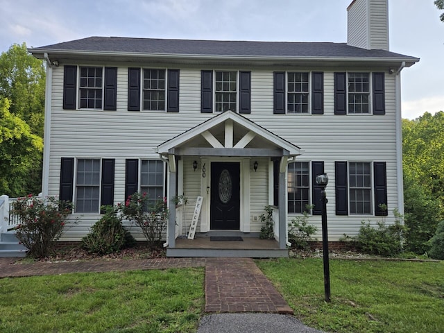 100 View Dr, Goodview, VA 24095 - colonial house featuring a front lawn and a chimney