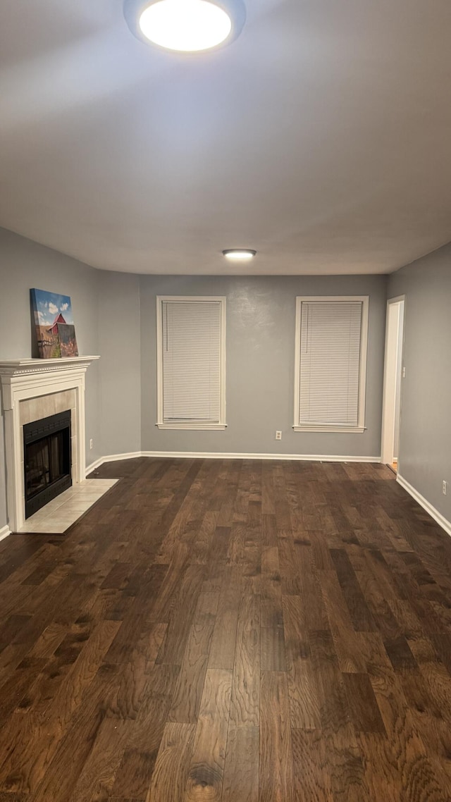 100 View Dr, Goodview, VA 24095 - basement with dark wood finished floors, a tiled fireplace, and baseboards