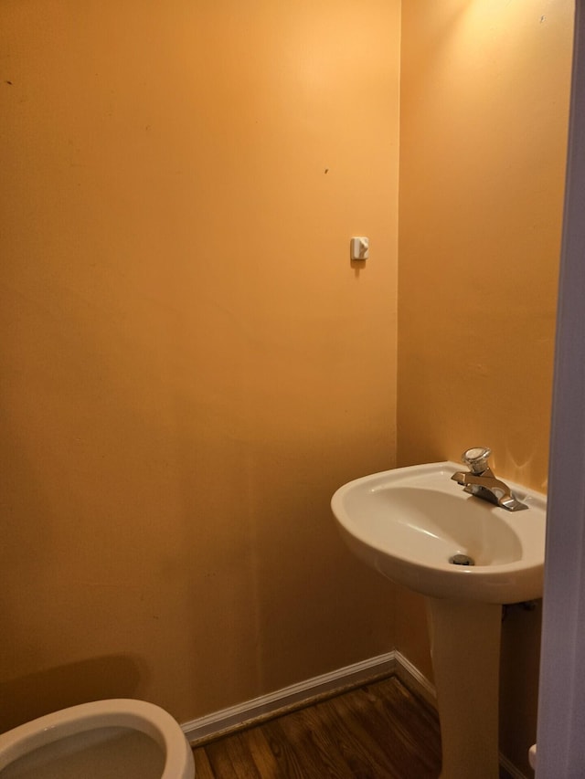 100 View Dr, Goodview, VA 24095 - bathroom featuring toilet, wood finished floors, baseboards, and a sink