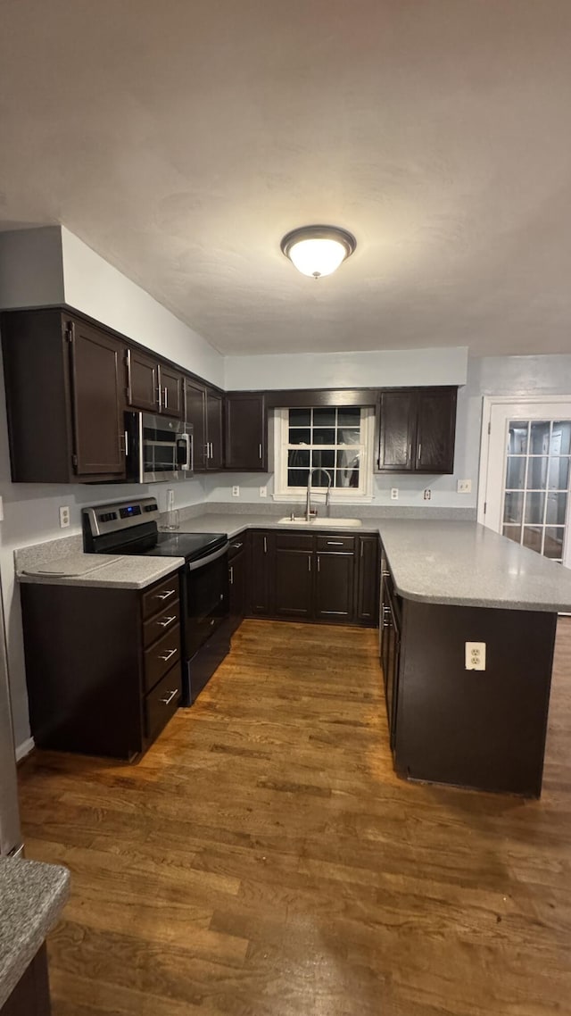 100 View Dr, Goodview, VA 24095 - kitchen featuring appliances with stainless steel finishes, a sink, a peninsula, and dark wood-type flooring