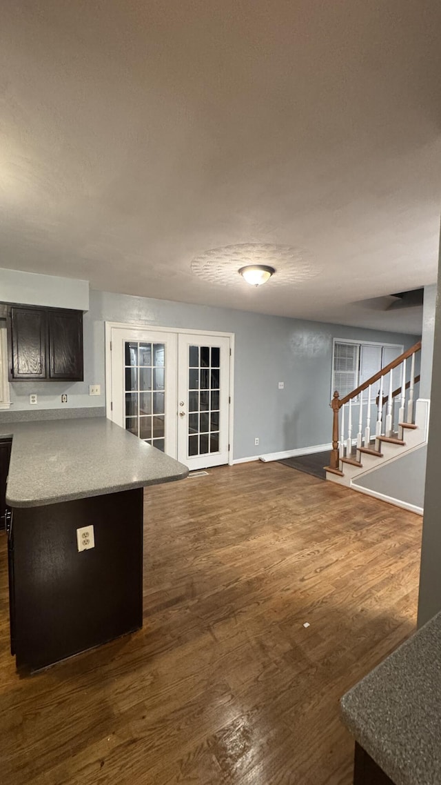 100 View Dr, Goodview, VA 24095 - unfurnished living room with french doors, stairway, baseboards, and dark wood-style floors