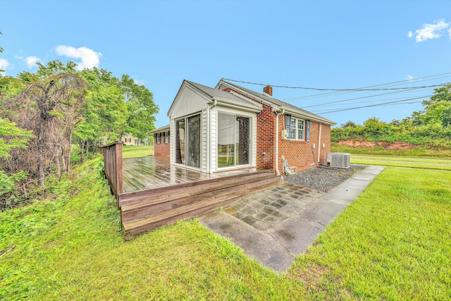1841 Old Franklin Tpke, Rocky Mount, VA 24151 - view of property exterior featuring a lawn, a deck, cooling unit, and brick siding