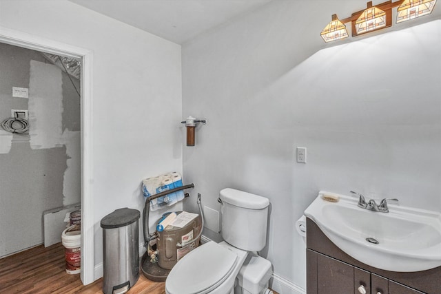 1841 Old Franklin Tpke, Rocky Mount, VA 24151 - bathroom with wood finished floors, toilet, vanity, and baseboards