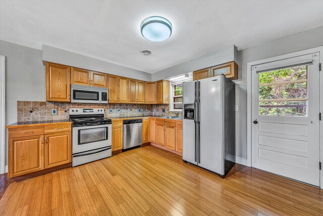 1841 Old Franklin Tpke, Rocky Mount, VA 24151 - kitchen featuring appliances with stainless steel finishes, healthy amount of natural light, light wood-style floors, and decorative backsplash