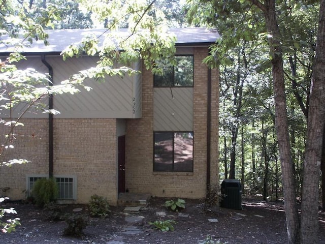 view of side of home featuring brick siding