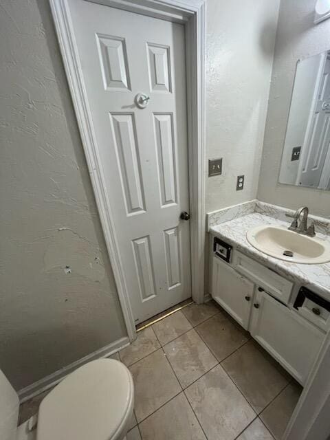 bathroom featuring tile patterned floors, toilet, and vanity