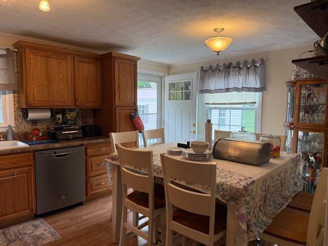 1134 Coolbrook Rd, Bedford, VA 24523 - kitchen with stainless steel dishwasher, healthy amount of natural light, brown cabinetry, a textured ceiling, and ornamental molding