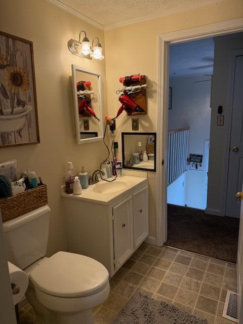 1134 Coolbrook Rd, Bedford, VA 24523 - half bathroom featuring vanity, toilet, ornamental molding, and a textured ceiling
