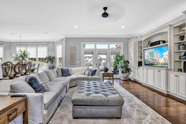 living area featuring ornamental molding, dark wood-style flooring, recessed lighting, and built in features