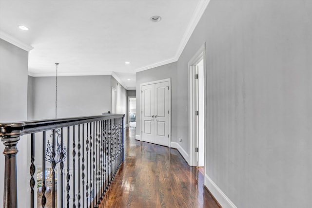 hall with dark wood-style floors, crown molding, baseboards, and recessed lighting