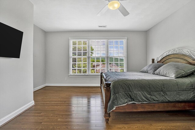 bedroom with wood finished floors, baseboards, and a ceiling fan