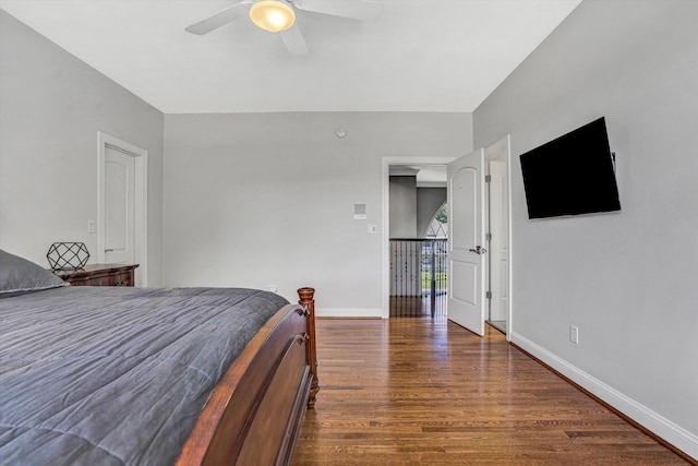 bedroom featuring wood finished floors, baseboards, and ceiling fan