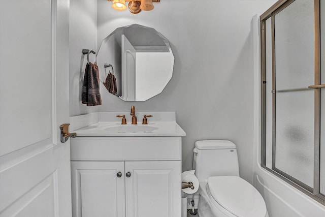 full bathroom featuring vanity, toilet, and combined bath / shower with glass door