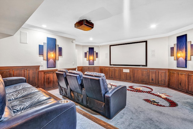 home theater featuring carpet floors, crown molding, recessed lighting, and wainscoting