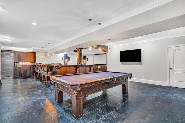 game room with bar area, baseboards, ornamental molding, dark stone finish flooring, and recessed lighting
