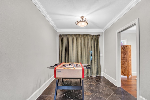 game room with ornamental molding and baseboards