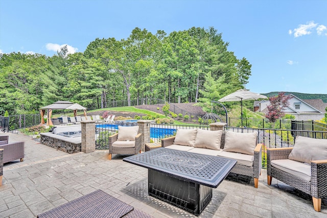 fenced backyard with an outdoor living space, a gazebo, and a patio area