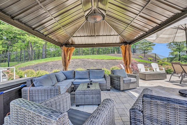 fenced backyard with an outdoor living space, a gazebo, and a patio