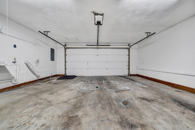 garage featuring electric panel and baseboards