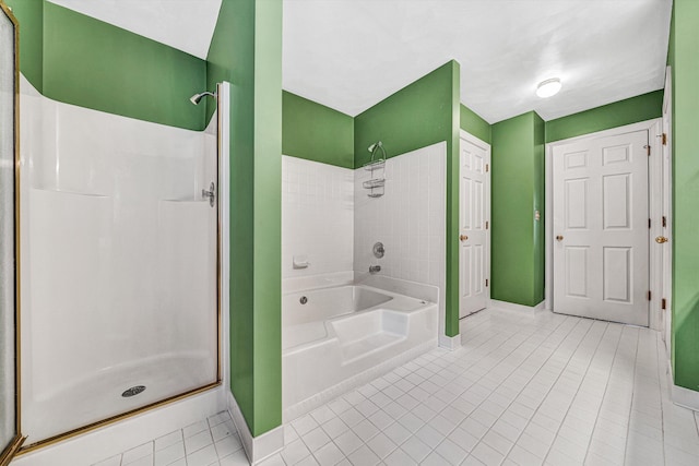 bathroom featuring a shower, tile patterned flooring, and baseboards