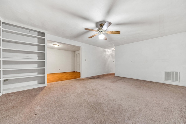 unfurnished living room featuring carpet and a ceiling fan