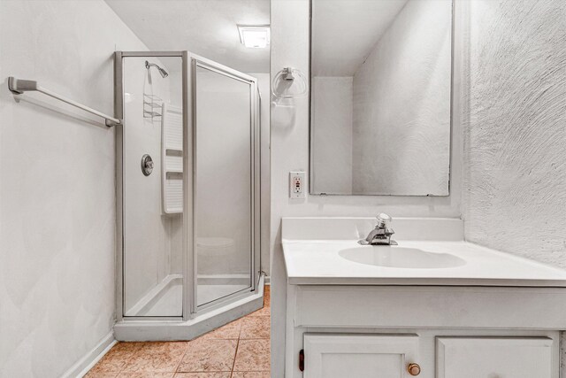 bathroom featuring vanity, tile patterned flooring, and a shower stall