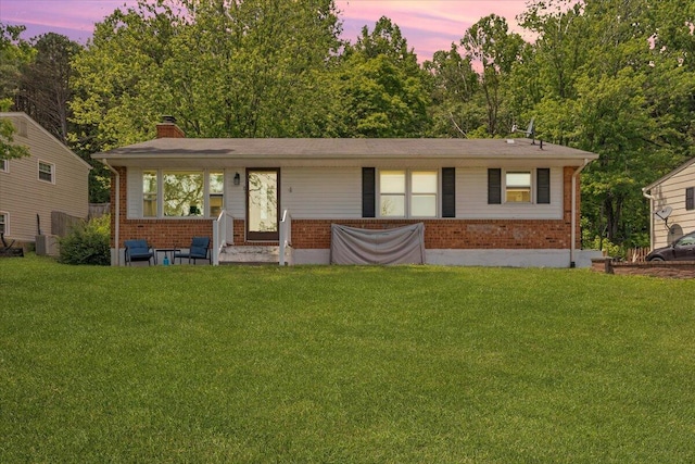 81 Ridgeview Cir, Roanoke, VA 24019 - view of front of house with brick siding, a front yard, and a chimney