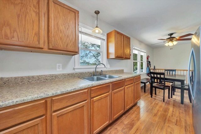 81 Ridgeview Cir, Roanoke, VA 24019 - kitchen featuring a sink, freestanding refrigerator, light wood-style floors, and light countertops