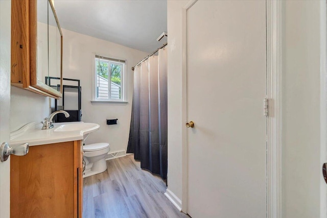 81 Ridgeview Cir, Roanoke, VA 24019 - bathroom with toilet, wood finished floors, vanity, baseboards, and a shower with shower curtain