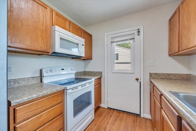 81 Ridgeview Cir, Roanoke, VA 24019 - kitchen with white appliances, light wood-style floors, light countertops, and brown cabinets