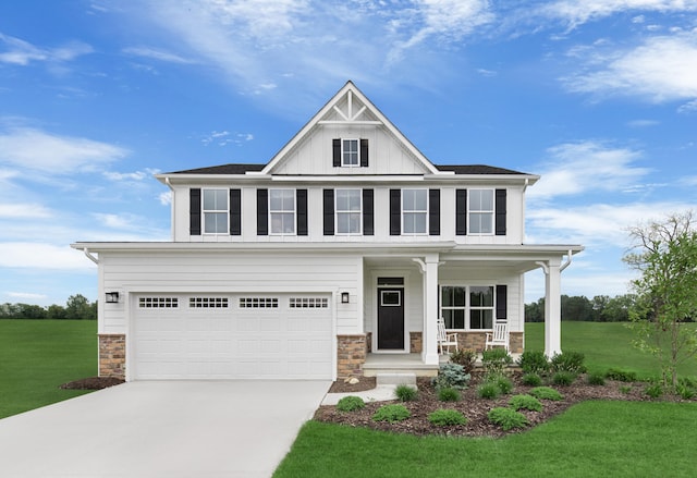 view of front of home featuring concrete driveway, stone siding, a porch, and a front yard