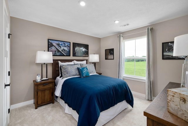 bedroom featuring light carpet, baseboards, and recessed lighting