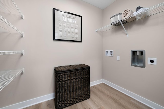 clothes washing area featuring washer hookup, baseboards, wood finished floors, and hookup for an electric dryer
