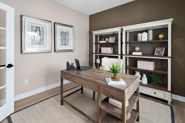 office featuring baseboards and wood finished floors