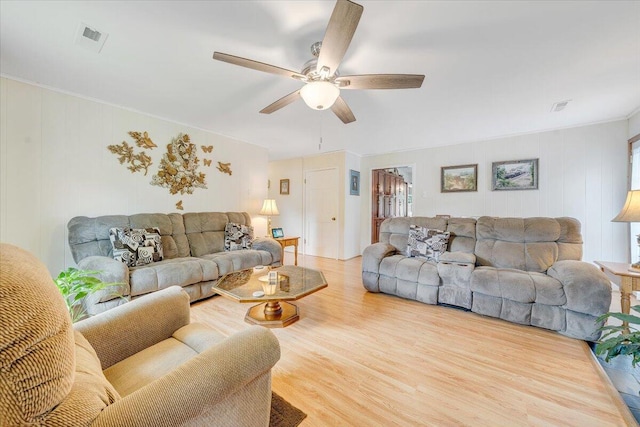 living room with a ceiling fan and wood finished floors