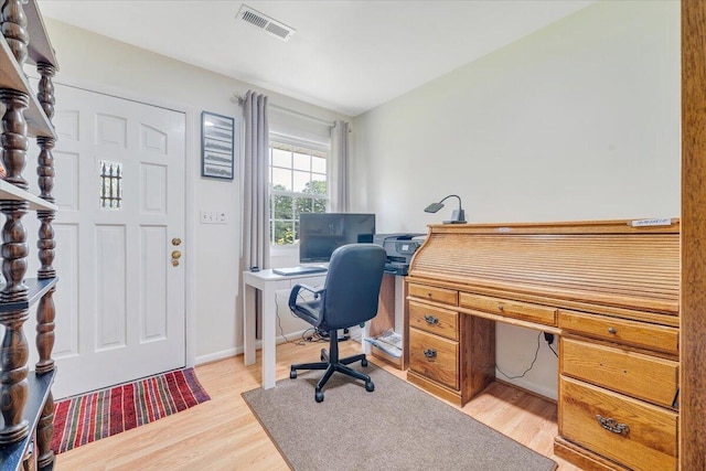 home office with light wood-style flooring