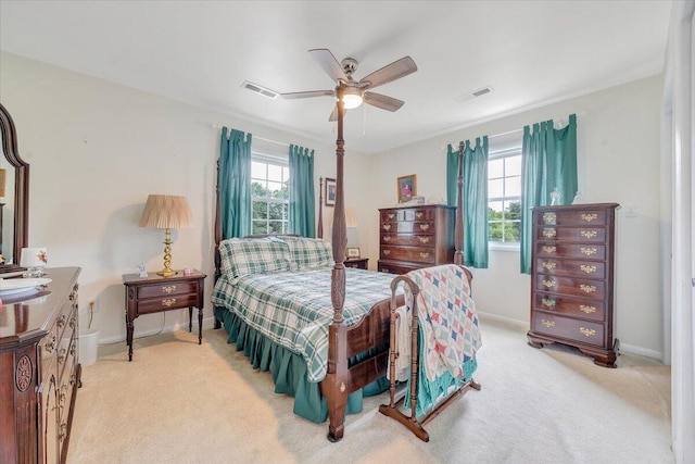 carpeted bedroom with baseboards and ceiling fan