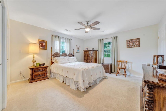 bedroom with carpet, multiple windows, baseboards, and ceiling fan