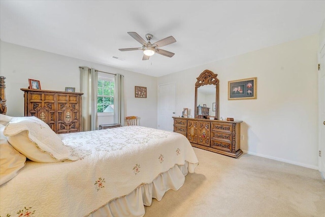 bedroom featuring light carpet, baseboards, and a ceiling fan