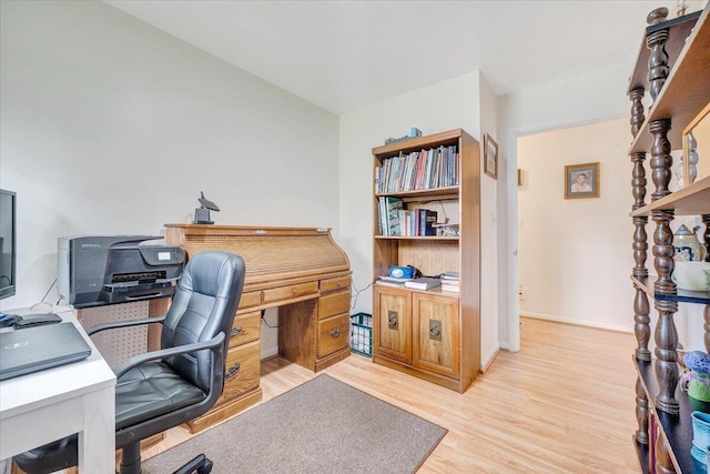 office with light wood-type flooring and baseboards