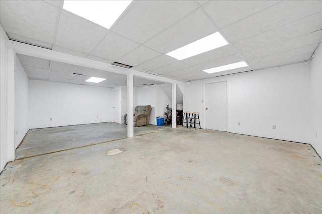 finished basement featuring a drop ceiling