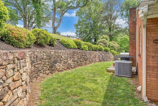view of grassy yard featuring central AC unit