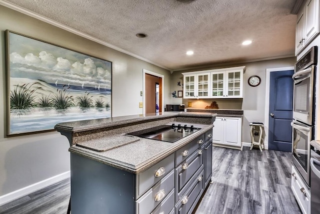 1530 Ridgeview Rd, Floyd, VA 24091 - kitchen with black electric cooktop, white cabinetry, dark wood finished floors, recessed lighting, and a kitchen island