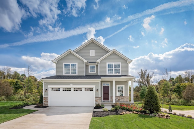 view of front of house with concrete driveway, stone siding, a front lawn, and a garage