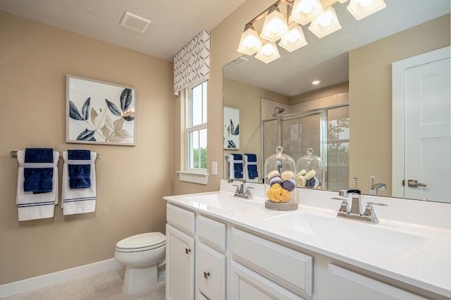 bathroom featuring toilet, a stall shower, a skylight, baseboards, and tile patterned flooring