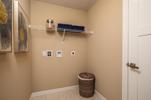 clothes washing area featuring hookup for an electric dryer, washer hookup, baseboards, and tile patterned flooring