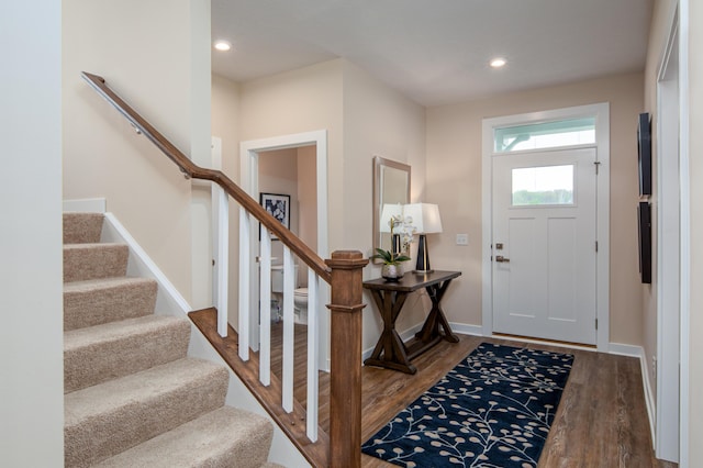 entrance foyer featuring stairs, wood finished floors, baseboards, and recessed lighting
