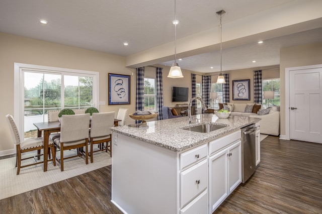 kitchen with a sink, open floor plan, dishwasher, dark wood finished floors, and white cabinetry